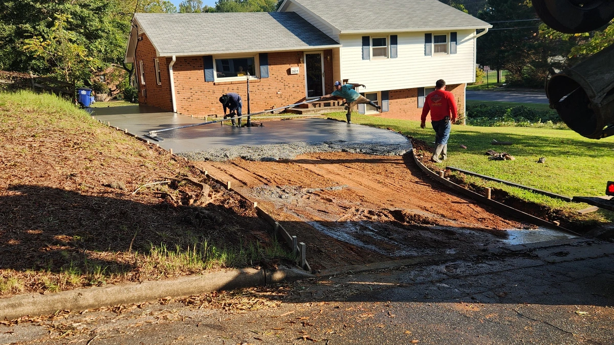 Aerial view of a freshly poured concrete driveway on a Charlotte home