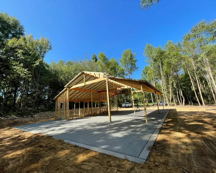 Concrete pad poured under a timber framed pole barn