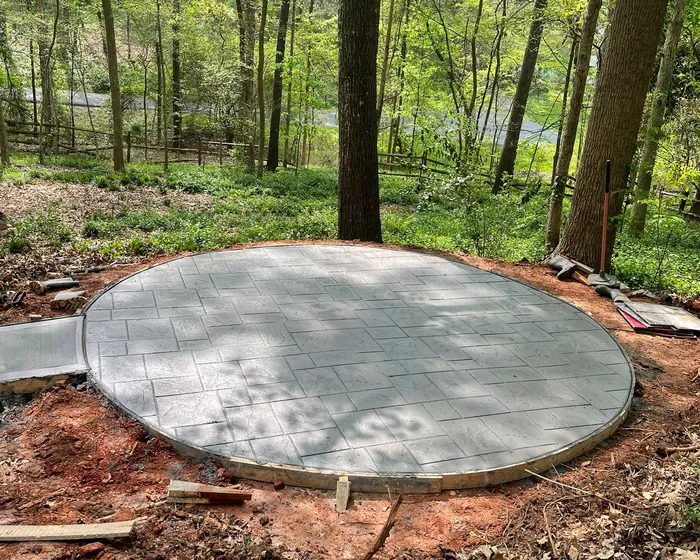 Circular concrete pad poured on a wooded lot